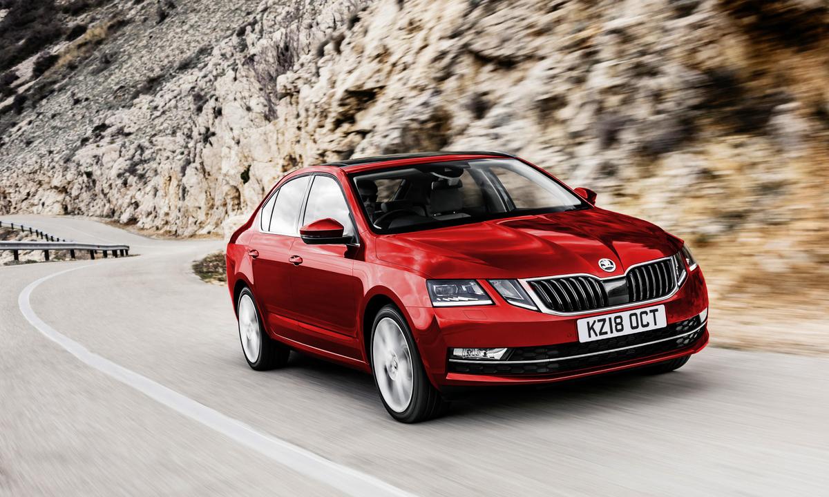 Red Skoda driving outdoors